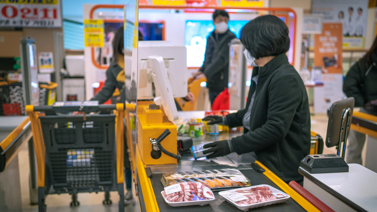 A woman working at a cash register in a shop