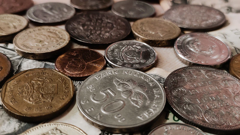 A pile of coins sitting on top of a pile of money