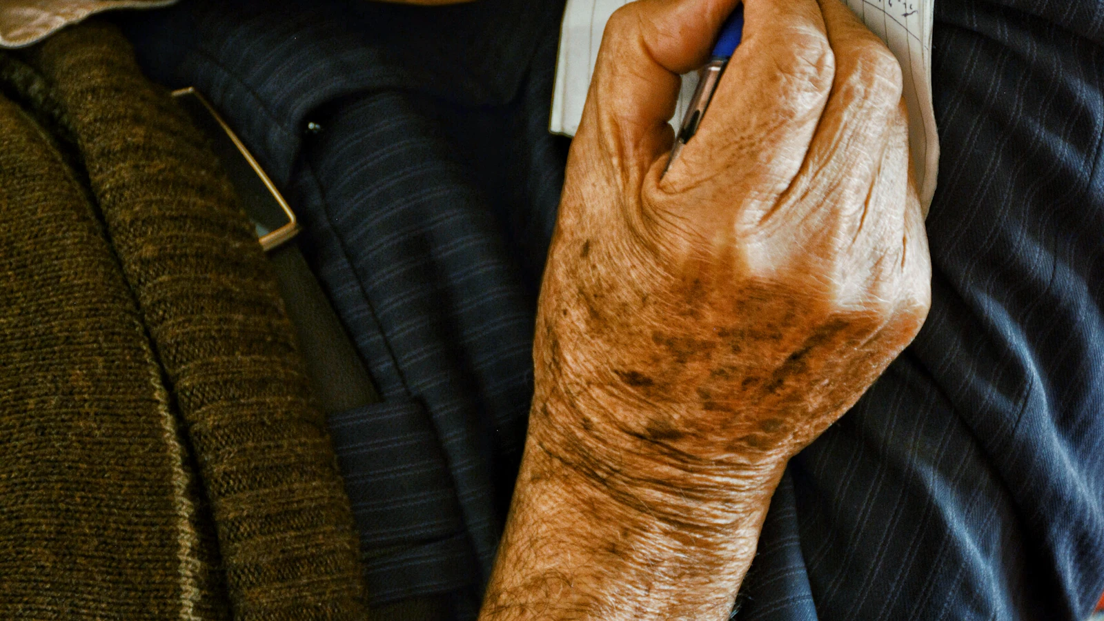 An old man holding a piece of paper