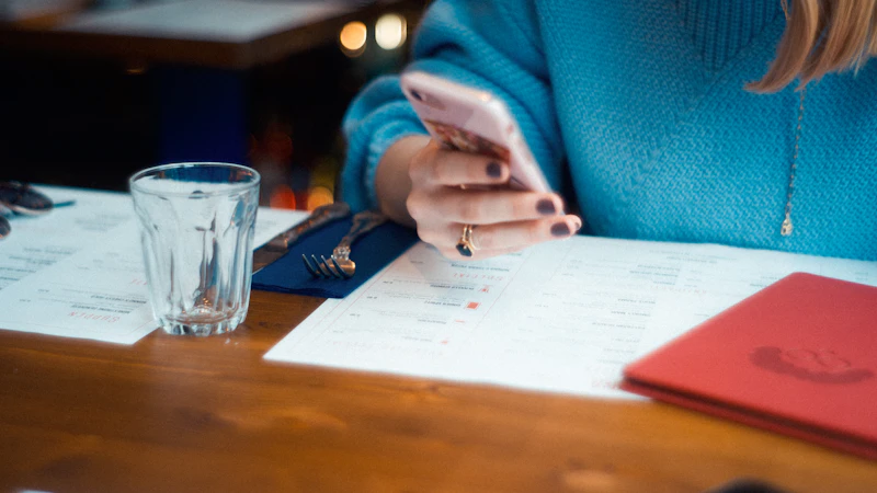 A person using a white smartphone