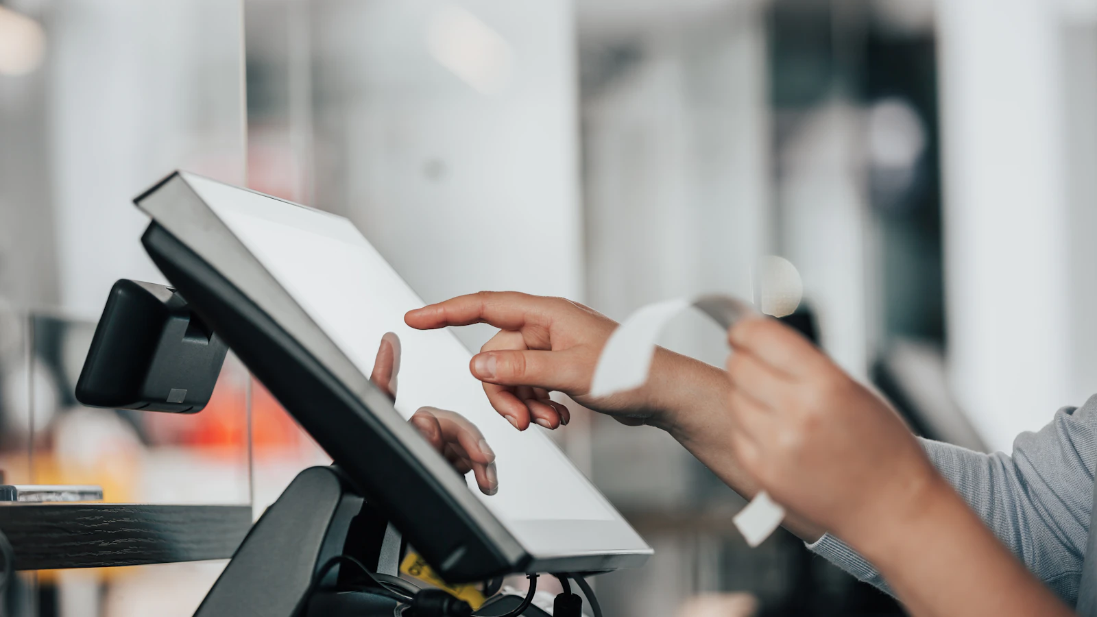 A person using a POS machine in a store